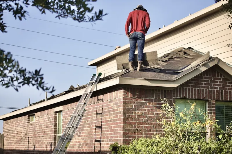 Professional roofer working on a residential roof in Wood Oaks Glen